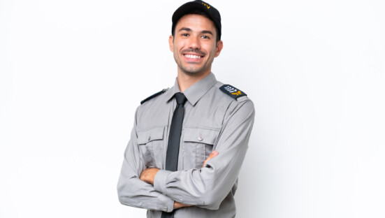 Young safeguard man over isolated white background with arms crossed and looking forward